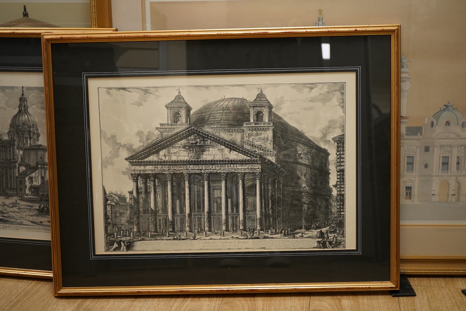 A pair of modern architectural colour prints together with a pair of decorative prints after Piranesi to include: Arco Di Settimio Severo, largest 48 x 73cm, all framed